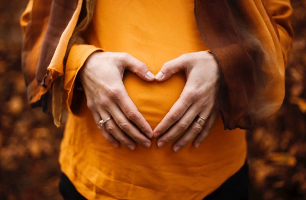woman with hands on stomach